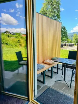 a screened in porch with a bench and a table at Apartment Kovacic - Lake Bled in Bled