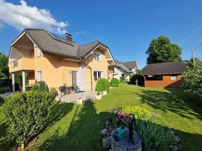 a large house with a yard with a yard at Apartma Aurora in Hraše