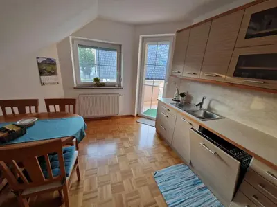 a kitchen with a sink and a table in a room at Apartma Aurora in Hraše