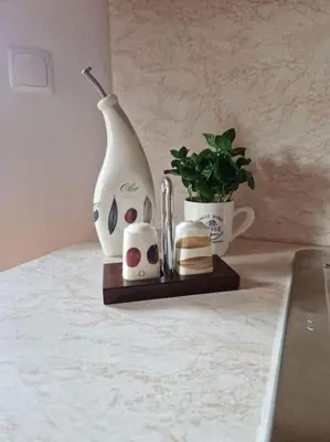 a table with a lamp and a potted plant at Apartma Aurora in Hraše
