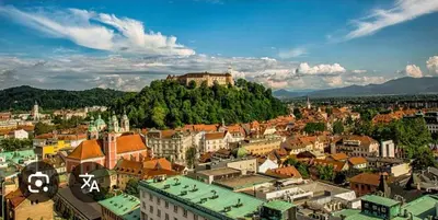 a city with a castle on top of a hill at Garsonjera in Ljubljana
