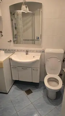 a bathroom with a toilet and a sink and a mirror at Garsonjera in Ljubljana