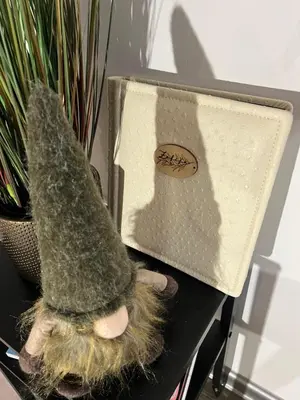 a hat sitting on a table next to a plant at Apartma - Hiša Zofija in Slovenske Konjice