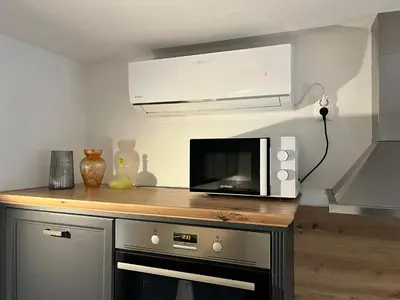 a microwave sitting on top of a counter in a kitchen at Apartma - Hiša Zofija in Slovenske Konjice