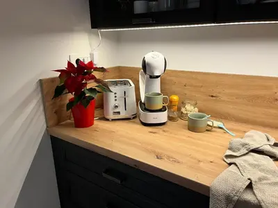 a counter with a coffee maker and cups on it at Apartma - Hiša Zofija in Slovenske Konjice