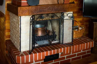 a brick fireplace with a pot in it at Charming Bled Home - Big Garden, BBQ & Free Bikes in Bled