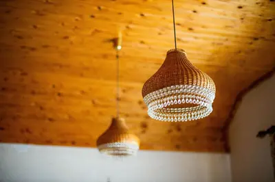 two chandeliers hanging from a wooden ceiling at Charming Bled Home - Big Garden, BBQ & Free Bikes in Bled