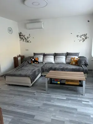 a bedroom with a bed and a coffee table at Apartma in Wellness Sladka Gora in Šmarje pri Jelšah