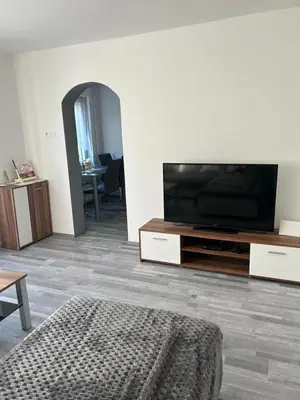 a living room with a flat screen tv on a entertainment center at Apartma in Wellness Sladka Gora in Šmarje pri Jelšah