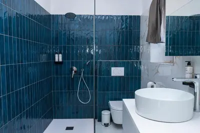 a bathroom with a shower with a toilet and a sink at Villa Avrelia in Ljubljana