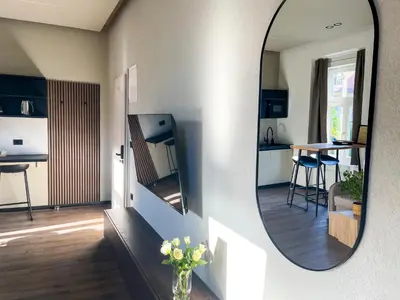 a mirror reflecting a kitchen and a living room at Villa Avrelia in Ljubljana