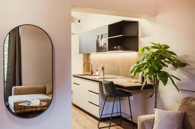 a bathroom with a mirror and a kitchen with a sink at Villa Avrelia in Ljubljana