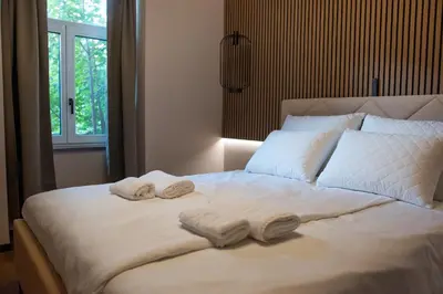 a bedroom with a bed with two towels on it at Villa Avrelia in Ljubljana