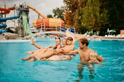 a group of people in the water at a water park at Hotel Toplice - Terme Čatež in Čatež ob Savi