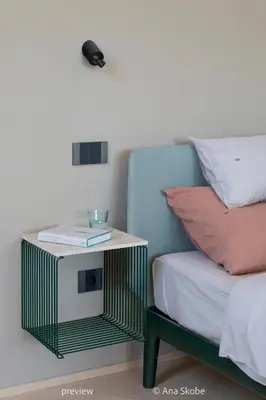 a bed with a side table next to a bed at Vila Slatina Weinderer in Svečina