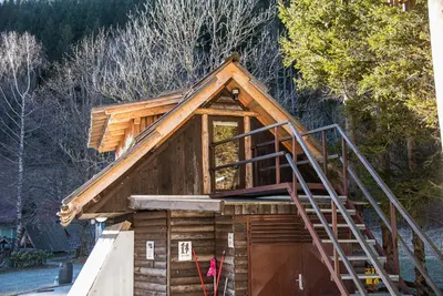a tiny house with a staircase on the side of it at Camping & Glamping Jezersko ex Cvet Gora in Zgornje Jezersko