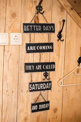 a group of signs hanging on a wooden wall at Camping & Glamping Jezersko ex Cvet Gora in Zgornje Jezersko
