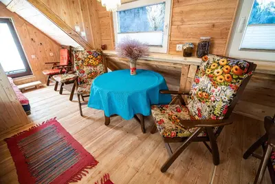 a dining room with a blue table and chairs at Camping & Glamping Jezersko ex Cvet Gora in Zgornje Jezersko