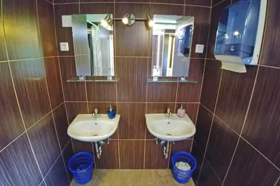 a bathroom with two sinks and two mirrors at Camping & Glamping Jezersko ex Cvet Gora in Zgornje Jezersko