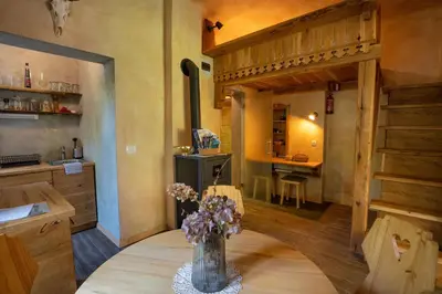 a kitchen with a vase of flowers on a table at Alpine styled apartment in central BLED in Bled