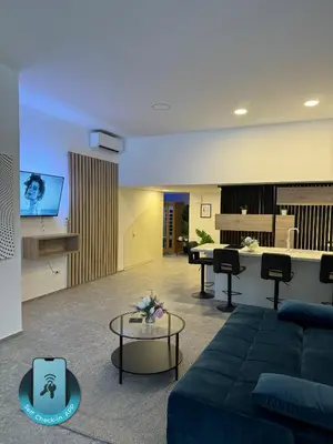a living room with a couch and a table at Suite Appartments Gregorčičeva in Ljubljana