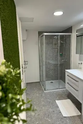 a bathroom with a shower with a glass door at Suite Appartments Gregorčičeva in Ljubljana