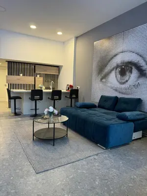a living room with a blue bed and a piano at Suite Appartments Gregorčičeva in Ljubljana