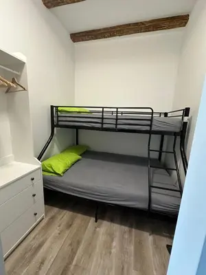 a bunk bed in a room with a wooden floor at Moulin a Vipava in Renče