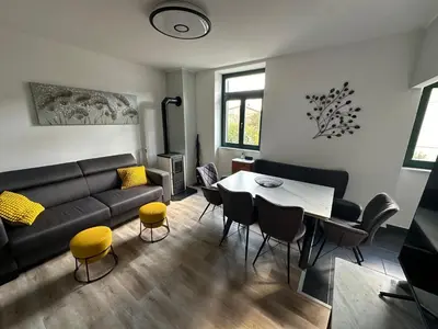 a living room with a couch and a table and chairs at Moulin a Vipava in Renče