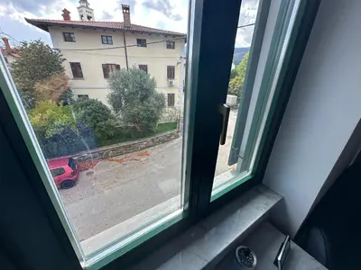 a window with a view of a building at Moulin a Vipava in Renče
