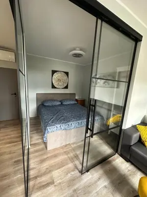 a bedroom with a bed and a glass wall at Moulin a Vipava in Renče