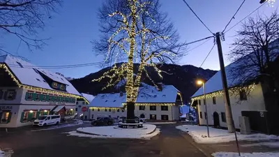 a small town with a christmas tree with lights on it at Apartment HANI in Kranjska Gora