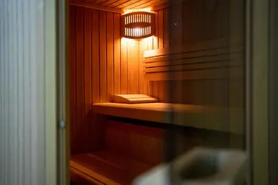 a small wooden sauna with a light in it at Hotel Tisa Pohorje in Pohorje