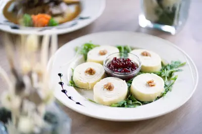a white plate of food on a table at Hotel Tisa Pohorje in Pohorje