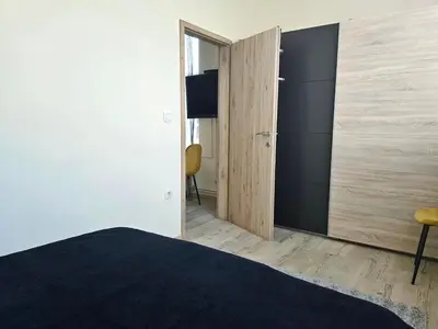 a bedroom with a bed and a sliding door at Apartments Rubis in Stožice