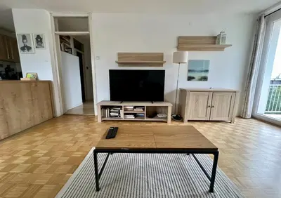 a living room with a tv and a coffee table at Pero cozy apartment in Ljubljana