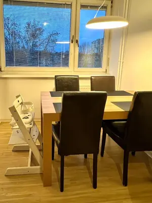 a dining room with a table and chairs and a window at Pero cozy apartment in Ljubljana