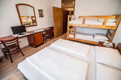a room with two bunk beds and a desk at Guesthouse Leski Dvor in Lesce