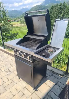 a barbecue grill sitting on top of a patio at Apartmaji Laznik in Ljubno