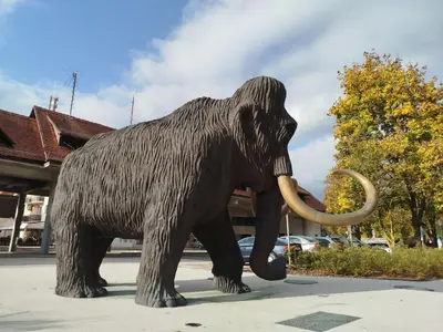 a statue of an elephant standing on a street at Apartma Mamut 1850 in Kamnik