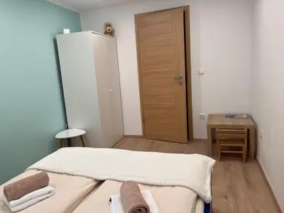 a bedroom with a bed and a desk and a closet at Pr Šemnič in Kamnik