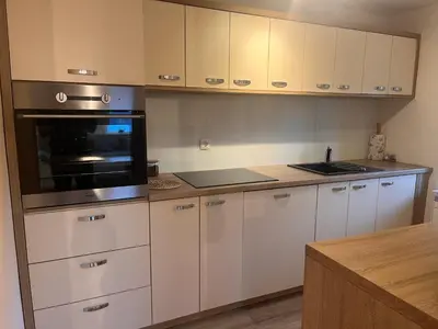 a kitchen with white cabinets and a stove top oven at Pr Šemnič in Kamnik