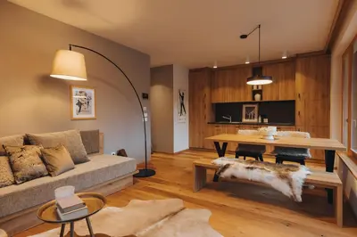 a living room with a couch and a table at Goldhorn Chalet SKI IN&OUT in Kranjska Gora