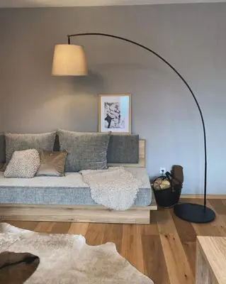 a living room with a bed and a lamp at Goldhorn Chalet SKI IN&OUT in Kranjska Gora
