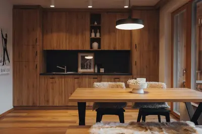 a dining room with a wooden table and chairs at Goldhorn Chalet SKI IN&OUT in Kranjska Gora