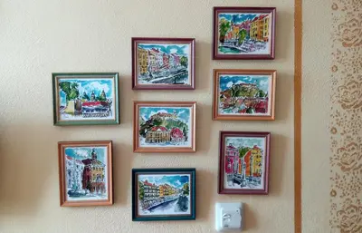 a group of pictures hanging on a wall at Ethno Apartments in Ljubljana