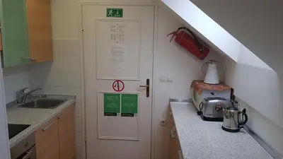 a kitchen with a door in the corner of a kitchen at Apartma Ravbar in Kranjska Gora