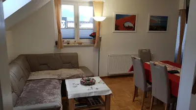 a living room with a couch and a table at Apartma Ravbar in Kranjska Gora