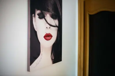 a picture of a woman with red lipstick at Rooms Ambrožič in Bled