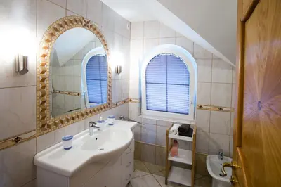 a bathroom with a sink and a mirror at Rooms Ambrožič in Bled